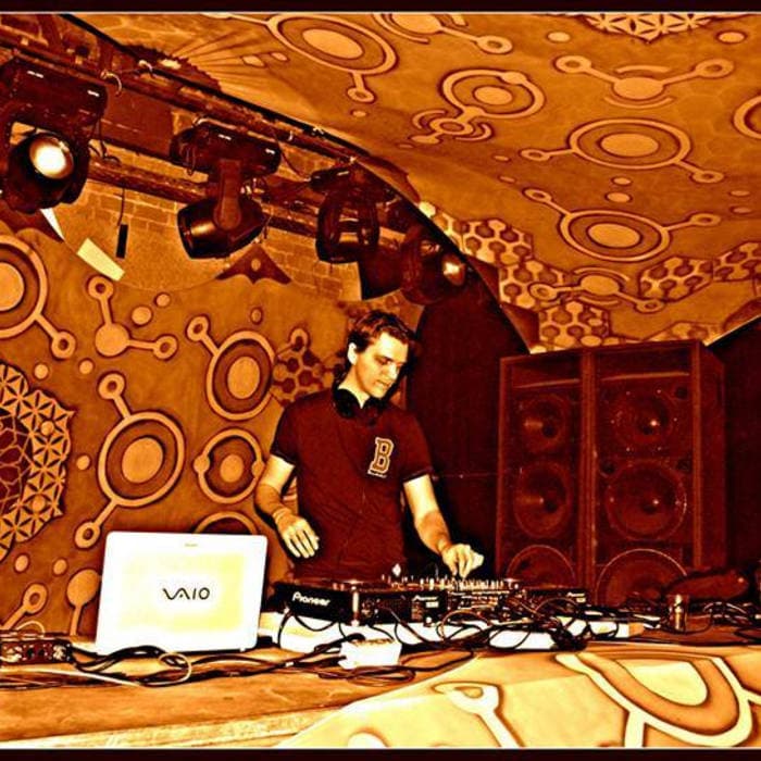 Wizack Twizack performing at a DJ booth under warm stage lights